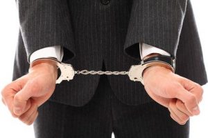 Close up of businessman hands in handcuffs